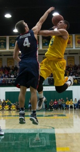 USF guard Matt Glover goes up for a shot against Gonzaga’s Kevin Pangos. Glover had eight points, eight rebounds, and five assists in the Dons loss to the Bulldogs. (Photo by Nicholas Welsh)