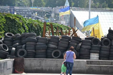A mother shows her child stacked tire barricades, left over from the protestors' clashes with riot police on Kiev's Independence Square. Courtesy of Daniela Schmiedlechner