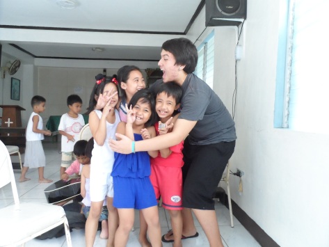 Junior Chris Lamelas plays with children during his semester abroad at Casa Bayanihan during fall 2013. PHOTO COURTESY OF UNIVERSITY MINISTRY