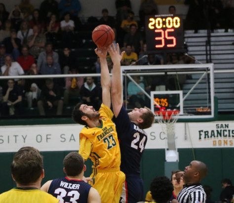 Starting forward Mark Tollefsen goes up for the jump ball to start off the game. John Holton/Foghorn