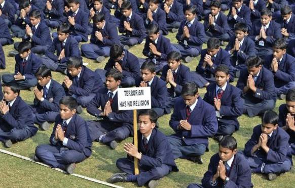 Indian schoolchildren praying for victims of the Taliban attack of the Army Public School. 
Photo CREDIT REUTERS/K. K. ARORA